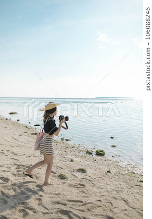 A woman walking along the beach 106088246