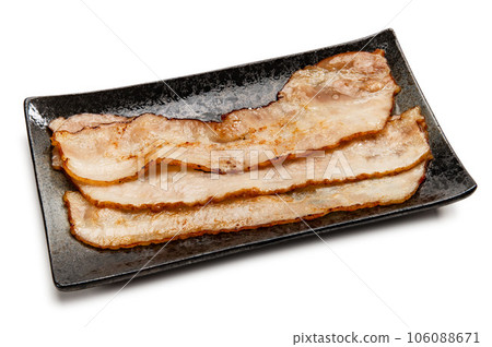 thinly sliced bacon fried in a frying pan thinly sliced bacon fried in a frying pan 106088671