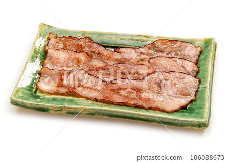 thinly sliced bacon fried in a frying pan thinly sliced bacon fried in a frying pan 106088673