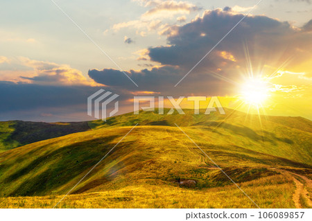 mountainous landscape at sunset. path through hill side to the mountain top. beautiful countryside scenery of ukrainian carpathians in evening light 106089857