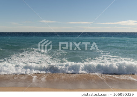 Warm day on a Cannes beach with azure waves of mediterranean sea 106090329