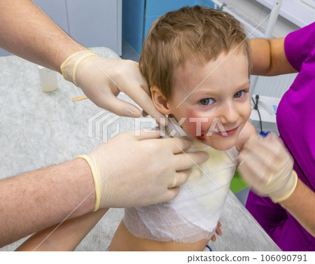 dressing a boy with a burn from boiling water 106090791