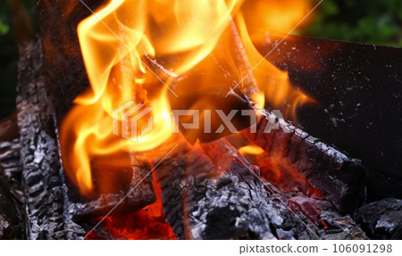 Close-up burning firewood in fire, black coals Close-up burning firewood in fire, black coals 106091298