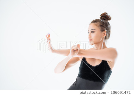 Beautiful sporty woman in black sportswear posing on white background with copy space. 106091471