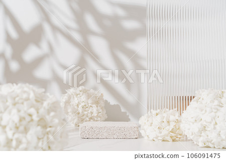 Cosmetics skin care product presentation scene made with empty pumice stone podium and white flowers on bathroom shelf. 106091475