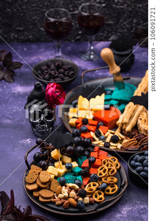 Halloween appetizers. Cheese plate with snacks 106091721