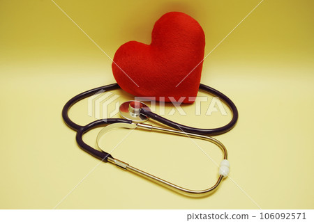 Red heart and Stethoscope on yellow background 106092571
