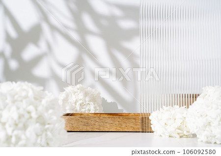 Cosmetics skin care product presentation scene made with empty wooden tray and white flowers on bathroom shelf. Studio photography. 106092580
