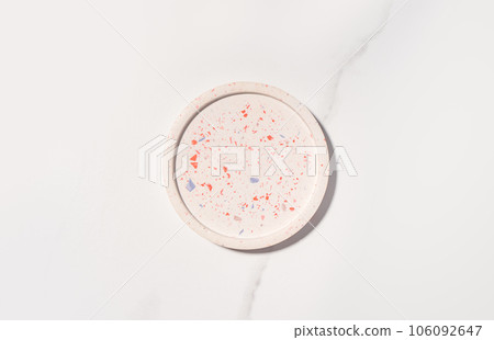 Beauty cosmetics product presentation flat lay mockup scene with beige terrazzo circle shape on white marble table with copy space. Trendy sunlight,  top view. Studio photography. 106092647