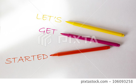 The text Let's Get Started written in a multicolored felt-tip pen on a white background. 106093258