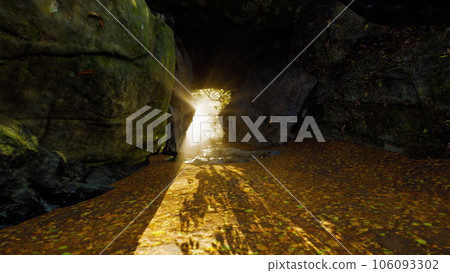 Shaft of light beaming down into large cave Shaft of light beaming down into large cave 106093302