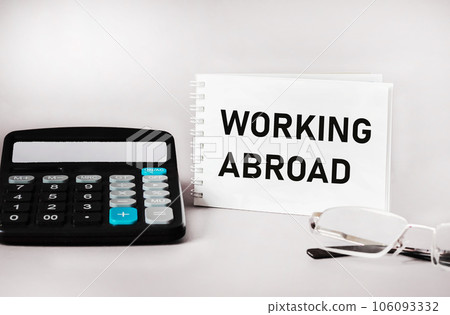 working abroad. text on a notepad on a light background. business concept 106093332