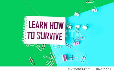 Text on Notepad Learn How to Survive. Survival in times of crisis business concept. Survival during  106093364