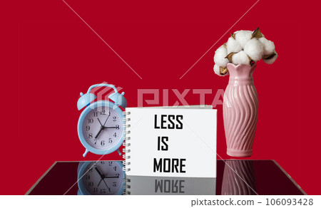 Text Less is more scale concept on red and black background. 106093428