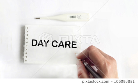 The text of the day of care, a woman's hand writes on a notebook, next to a thermometer The text of the day of care, a woman's hand writes on a notebook, next to a thermometer 106093881