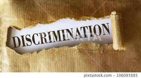 Discrimination is written on torn brown paper. Discrimination concept. 106093885
