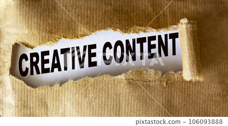 Text Creative content is written on torn brown paper. 106093888