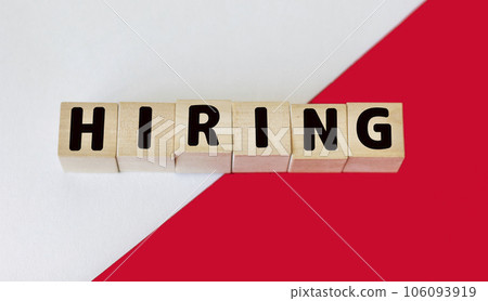 HIRE word made from building blocks on red and white background HIRE word made from building blocks on red and white background 106093919