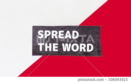 Text Spread the word on a black note and a red and white background. Business concept for launch Text Spread the word on a black note and a red and white background. Business concept for launch 106093925