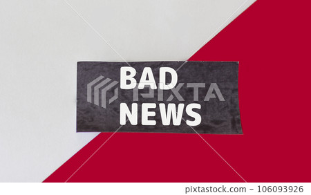 Bad news,text on black sticky note and red and white background. 106093926