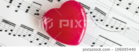 Red heart on paper with musical notes close-up. Red heart on paper with musical notes close-up. 106095440