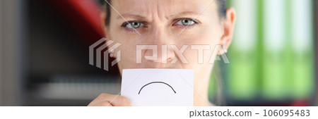 Angry woman holding card with negative emotion in front of her mouth. Angry woman holding card with negative emotion in front of her mouth. 106095483