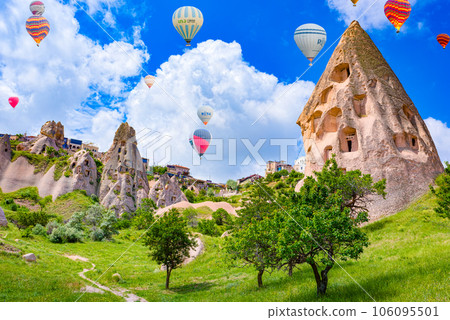 Cappadocia, Turkiye - July 07, 2023-Air balloons in Cappadocia-the ancient Uchisar Castle fortress. Cappadocia, Turkiye - July 07, 2023-Air balloons in Cappadocia-the ancient Uchisar Castle fortress. 106095501