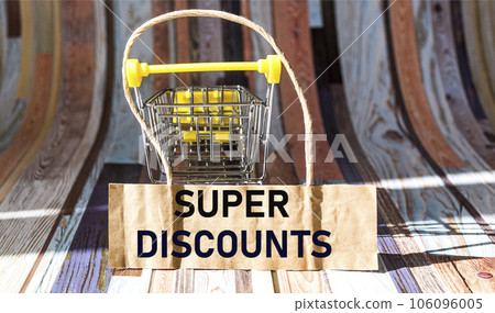 text SUPER DISCOUNTS next to a small cart for goods. Seasonal sale. Black Friday text SUPER DISCOUNTS next to a small cart for goods. Seasonal sale. Black Friday 106096005