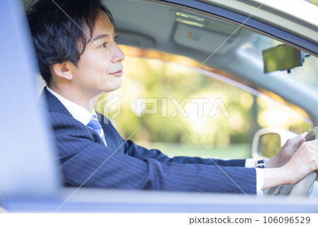 Businessman driving a car Businessman driving a car 106096529
