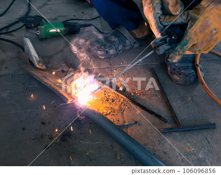 Man welding steel, blurred on black background Man welding steel, blurred on black background 106096856