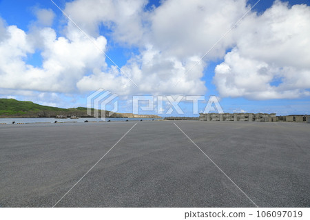 Wide asphalt plaza in Sona Port, Yonaguni Island where tropical clouds float Wide asphalt plaza in Sona Port, Yonaguni Island where tropical clouds float 106097019