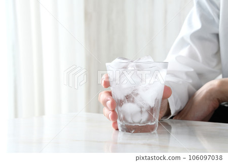 A man's hand holding shochu with water A man's hand holding shochu with water 106097038