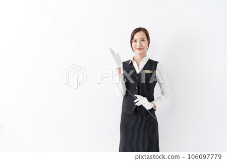 Woman in uniform, white gloves, holding hands Woman in uniform, white gloves, holding hands 106097779