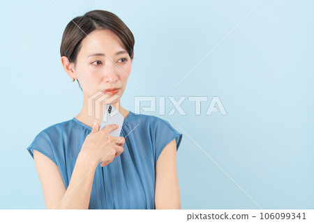 Woman holding a smartphone Woman holding a smartphone 106099341