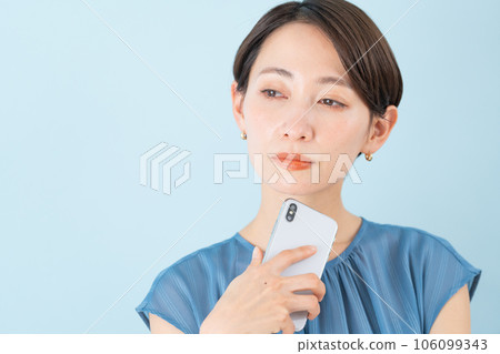 Woman holding a smartphone Woman holding a smartphone 106099343