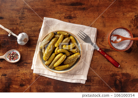 Pickled cucumbers with salt, pepper, and garlic. Fermented food 106100354