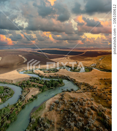 Summer scenery aerial view of winding river in beautiful valley at sunset Summer scenery aerial view of winding river in beautiful valley at sunset 106100612