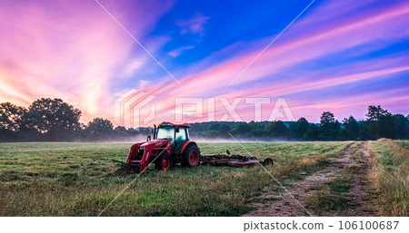 Working agicultural machinery on a sunny spring day - sunset or sunrise 106100687