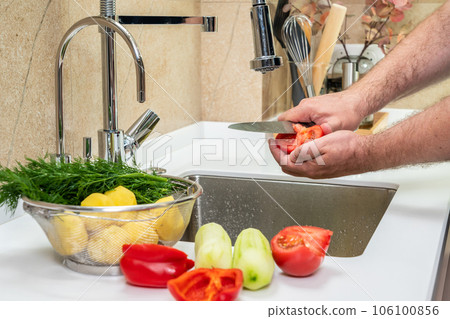 Cleaning and cutting fresh vegetables in the kitchen Cleaning and cutting fresh vegetables in the kitchen 106100856