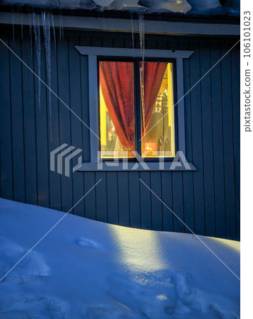 mountain hut and window light in the snow in the evening mountain hut and window light in the snow in the evening 106101023