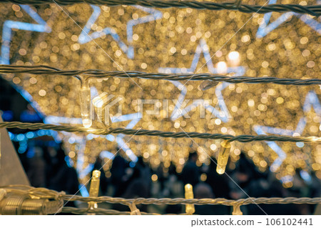 Christmas illumination LED lights garlands close up with stars in background Christmas illumination LED lights garlands close up with stars in background 106102441