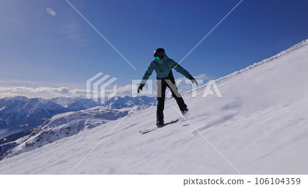 Snowboarder on piste in high mountains, freeze motion 106104359