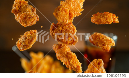 Freeze motion shot of flying tasty fried chicken wings or strips 106104393