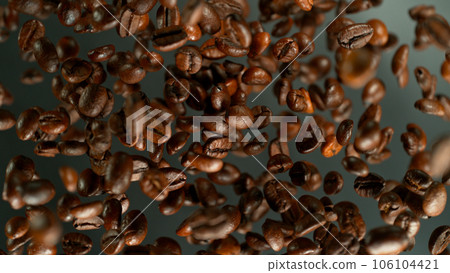 Freeze Motion Shot of Flying and Rotating Coffee Beans, Dark Background 106104421