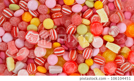 Freeze motion of flying various kind of candies. Colored abstract sweet background. Freeze motion of flying various kind of candies. Colored abstract sweet background. 106104451