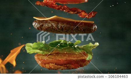 Beef Burger with Ingredients Falling and Landing in the Bun Beef Burger with Ingredients Falling and Landing in the Bun 106104463