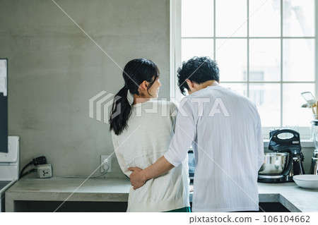 Couple having a conversation in the kitchen at home Couple having a conversation in the kitchen at home 106104662