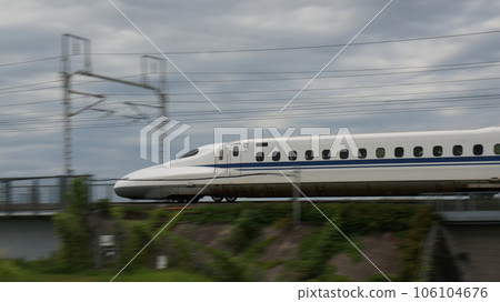 Shinkansen speeding on iron bridge 106104676