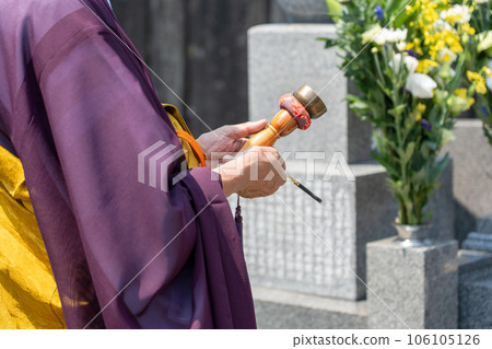 A monk recites in front of the Perpetual Memorial Cemetery A monk recites in front of the Perpetual Memorial Cemetery 106105126