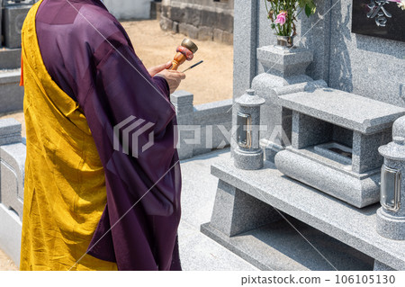 A monk recites in front of the Perpetual Memorial Cemetery 106105130